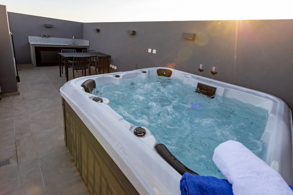A private rooftop jacuzzi at a MrBNB-managed apartment in Sunset Gardens